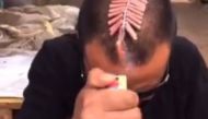 A screenshot from Kuaishou shows a man setting off firecrackers on his head. Kuaishou, which runs a live-streaming social media platform similar to Twitter Inc.’s Periscope and Facebook Inc.’s Instagram, was founded in 2011, its website shows. (Image cour