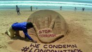  Indian sandartist Sudarsan Pattnaik gives the final touches to a sand sculpture on Puri Beach, some 65kms from Bhubaneswar on March 23, 2017, the day after an attack in London. Seven people have been arrested including some in London and Birmingham over 