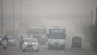 In this photograph taken on November 7, 2016 Indian commuters journey along a major road as heavy smog covers in New Delhi (AFP) 