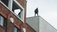 Men on the roof near FACT