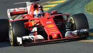 Ferrari's German driver Sebastian Vettel powers through a corner during the Formula One Australian Grand Prix in Melbourne on March 26, 2017. / AFP / PAUL CROCK
