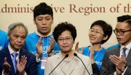 Hong Kong's new chief executive Carrie Lam (C) reacts at a press conference after she won the Hong Kong chief executive election in Hong Kong on March 26, 2017.   AFP / ANTHONY WALLACE
