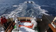 (file Photo) Lifeguards from the Spanish NGO Proactiva Open Arms sanitise five dead bodies of migrants on-board the former fishing trawler Golfo Azzurro following a search and rescue operation in central Mediterranean Sea off the Libyan coast, March 24, 2