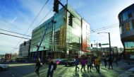 People walk past part of the new Amazon headquarters complex under construction in Seattle, Washington. 