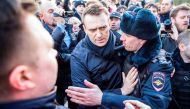 This handout picture taken and provided by Evgeny Feldman for Alexei Navalny's campaign on March 26, 2017 shows police officers detaining Kremlin critic Alexei Navalny during an unauthorised anti-corruption rally in central Moscow. AFP PHOTO / Evgeny Feld