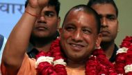 In this photograph taken on March 18, 2017, new Chief Minister of the northern Indian state of Uttar Pradesh Yogi Adityanath gestures to supporters as he is presented with a floral bouquet during a ceremony in Lucknow. AFP 
