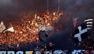 (FILES) This file photo taken on September 17, 2016 in Belgrade shows supporters of Partizan Belgrade throwing smoke grenades on the tribunes during the Serbian first league match between Red Star and Partizan. AFP / PEDJA MILOSAVLJEVIC
