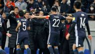 Japan's Maya Yoshida celebrates with team mates after he scored their fourth goal. REUTERS/Toru Hanai
