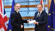 Britain's ambassador to the EU Tim Barrow delivers British Prime Minister Theresa May's formal notice of the UK's intention to leave the bloc under Article 50 of the EU's Lisbon Treaty to European Council President Donald Tusk in Brussels on March 29, 201