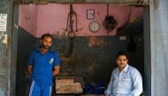 In this photograph taken on March 25, 2017, Indian butcher Riyaz Babu Qureshi (R) sits in his empty shop in the old quarters of Meerut. A zealous campaign to protect cows -- considered sacred by Hindus -- by a new right-wing government in Uttar Pradesh st