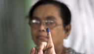 A woman shows her finger, which was inked after she cast her vote in a by-election, in a polling station in Dagon Seikkan township, eastern Yangon on April 1, 2017.  AFP / Ye Aung THU
