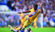 Crystal Palace's Ivorian-born English striker Wilfried Zaha (up) vies with Chelsea's English defender Gary Cahill during the English Premier League football match between Chelsea and Crystal Palace at Stamford Bridge in London on April 1, 2017. AFP / Glyn