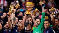 Paris Saint-Germain's Brazilian defender Thiago Silva (C) holds the trophy as he celebrates with teammates after winning the French League Cup final football match between Paris Saint-Germain (PSG) and Monaco (ASM) on April 1, 2017, at the Parc Olympique 