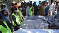 Pakistani volunteers wait to transport the bodies of victims who were murdered at a Sufi shrine by three suspects including the shrine's custodian on the outskirts of Sargodha District in Punjab province on April 2, 2017. Photo: AFP.