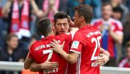 Bayern Munich's Robert Lewandowski celebrates with his teammates Franck Ribery and Thomas Mueller after scoring a goal. REUTERS/Michael Dalder  
