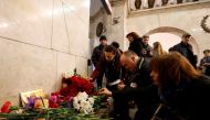 People leave candles in memory of victims of a blast in St.Petersburg metro, at Tekhnologicheskiy institut metro station in St. Petersburg, Russia, April 4, 2017. REUTERS/Grigory Dukor.