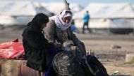 Internally displaced people who fled Raqqa city sit near tents in a camp in Ain Issa, north of Raqqa, Syria April 3, 2017. Picture taken April 3, 2017. REUTERS/Rodi Said
