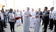 Sheikh Nawaf Nasser bin Khaled Al Thani, Chairman and CEO of NBK Holding, cutting the ribbon to open QAC Bodyshop at Street 18, Industrial Area in Doha, on Monday.