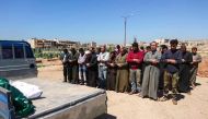 Syrians hold funeral prayers before they bury the bodies of victims of a a suspected toxic gas attack in Khan Sheikhun, a nearby rebel-held town in Syria's northwestern Idlib province, on April 5, 2017. AFP / FADI AL-HALABI