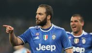 Juventus' forward from Argentina Gonzalo Higuain celebrates after scoring during the Tim Cup semifinal second leg football match SSC Napoli vs Juventus FC on April 5, 2017 at the San Paolo Stadium. / AFP / CARLO HERMANN
