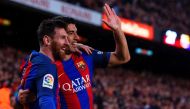 Barcelona's Argentinian forward Lionel Messi (L) is congratulated by Barcelona's Uruguayan forward Luis Suarez after scoring during the Spanish league football match FC Barcelona vs Sevilla FC at the Camp Nou stadium in Barcelona on April 5, 2017. / AFP /