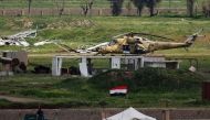 An Iraqi army helicopter sits in a field on the outskirts of western Mosul on April 3, 2017, during an offensive to retake the city from Islamic State (IS) group fighters. AFP / Ahmad Gharabli
