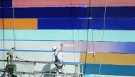 Painters  at work on a newly constructed building in Miami, Florida.