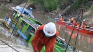 Rescue personnel from Myanmar's Fire Services Department refloat a ferry that sank in the Chindwin River in Sagaing region, October 19, 2016. (Photo by AFP).