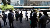 Office workers stand on the grounds of an office building in the financial district of Makati in Manila on April 8, 2017, after a 5.7 magnitude earthquake. A magnitude 5.7 earthquake rocked the Philippines on April 8, the US Geological Survey said, sendin