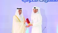 Deputy Prime Minister and Minister of State for Cabinet Affairs H E Ahmed bin Abdullah bin Zaid Al Mahmoud (left) presents the Moushtarayat National Award to Abdullah Fadhalah Al-Sulaiti, Managing Director of Nakilat during the event.