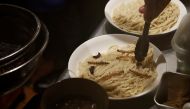 A chef places worms and crickets on a noodle as he serves 'insect tsukemen' noodle at 'Ramen Nagi' restaurant in Tokyo, Japan April 9, 2017. Picture taken on April 9, 2017. REUTERS/Kim Kyung-Hoon
