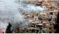 Smoke rises after clashes between members of Palestinian Fatah Movement and Bilal Badr at Ain-el-Hilwe refugee camp in Sidon, Lebanon on April 9, 2017. ( Ratib Al Safadi - Anadolu Agency ).