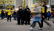 Police patrol outside the stadium prior to the UEFA Champions League 1st leg quarter-final football match BVB Borussia Dortmund v Monaco in Dortmund, western Germany on April 12, 2017. / AFP / SASCHA SCHUERMANN
