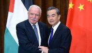 Chinese Foreign Minister Wang Yi (R) shakes hands with his Palestinian counterpart Riyad Al-Maliki before their meeting at the Ministry of Foreign Affairs in Beijing on April 13, 2017. / AFP / POOL / Parker Song