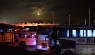 A picture taken on April 14, 2017 shows buses parked in Aleppo, waiting for militants and members of their families from Madaya and Zabadani, to board and to head to Ramousseh as part of the deal between the opposition and the Syrian government. AFP / Geo