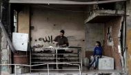 A Syrian man bakes a bread at his damaged bakery in the rebel-held town of Douma, on the eastern outskirts of the Syrian capital Damascus, on April 13, 2017. / AFP / Sameer Al-Doumy
