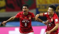 File photo: Paulinho (L) of China's Guangzhou Evergrande celebrates with teammate Zou Zheng after scoring against Mexico's Club America during their Club World Cup quarter-final soccer match in Osaka, western Japan, December 13, 2015. Reuters/Thomas Peter