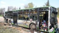 A picture taken on April 16, 2017, shows the damage a day after a suicide car bombing attack in Rashidin, west of Aleppo, targeted busses carrying Syrians evacuated from two besieged government-held towns of Fuaa and Kafraya.   AFP / Omar haj kadour
