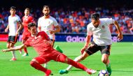 Sevilla's defender Sergio Escudero (L) vies with Valencia's Argentinian defender Ezequiel Garay during the Spanish league football match Valencia CF vs Sevilla FC at the Mestalla stadium in Valencia on April 16, 2017. / AFP / JOSE JORDAN
