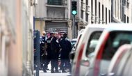 French policemen and demining experts are seen at the site of a police search on April 18, 2017 in the third district of Marseille, following the arrest of two men suspected of preparing an attack just days ahead of the first round of France's presidentia