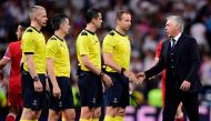 Bayern Munich's Italian head coach Carlo Ancelotti shakes hands with referees at the end of the UEFA Champions League quarter-final second leg football match Real Madrid vs FC Bayern Munich at the Santiago Bernabeu stadium in Madrid in Madrid on April 18,