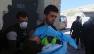 A man carries the body of a dead child, after what rescue workers described as a suspected gas attack in the town of Khan Sheikhoun in rebel-held Idlib, Syria April 4, 2017. REUTERS/Ammar Abdullah.