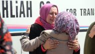 A Syrian woman, who was wounded in a car bomb blast on April 15 while waiting at a transit point during their evacuation from the sieged government-held towns of Kufraya and Fuaa in a deal made between the government and the rebels, greets a recently evac