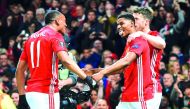 Manchester United striker Anthony Martial (left) celebrates with team-mates Marcus Rashford (centre) and Michael Carrick after their second goal during the UEFA Europa League quarter-final second leg match against Anderlecht at Old Trafford in Manchester,