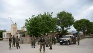 Afghan security personnel keep watch near the site of an ongoing attack on an army compound in Dihdadi District of Balkh province on April 21, 2017. AFP / FARSHAD USYAN