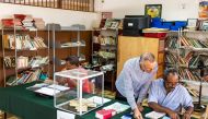 Polling station officials check on a voter list at a polling station on April 22, 2017 in Remire Montjoly, French Guiana during the first round of the French presidential election. / AFP / jody amiet
