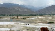 Afghan women walk through a village near the site of a bomb attack by US forces in the Achin district of Nangarhar province on April 22, 2017. Afghan authorities April 15 reported a jump in fatalities from the American military's largest non-nuclear bomb,