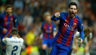 Barcelona's Argentinian forward Lionel Messi celebrates Barcelona's third goal during the Spanish league football match Real Madrid CF vs FC Barcelona at the Santiago Bernabeu stadium in Madrid on April 23, 2017.