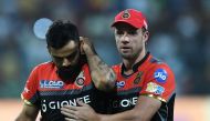 Royal Challengers Bangalore captain Virat Kohli reacts as teammate AB de Villiers(R) consoles him during the 2017 Indian Premier League (IPL) Twenty20 cricket match between Kolkata Knight Riders and Royal Challengers Bangalore at The Eden Gardens Cricket 