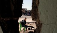A member of the Iraqi Federal Police sits in guard during their fighting the Islamic State in western Mosul, Iraq, April 24, 2017. REUTERS/Muhammad Hamed 

